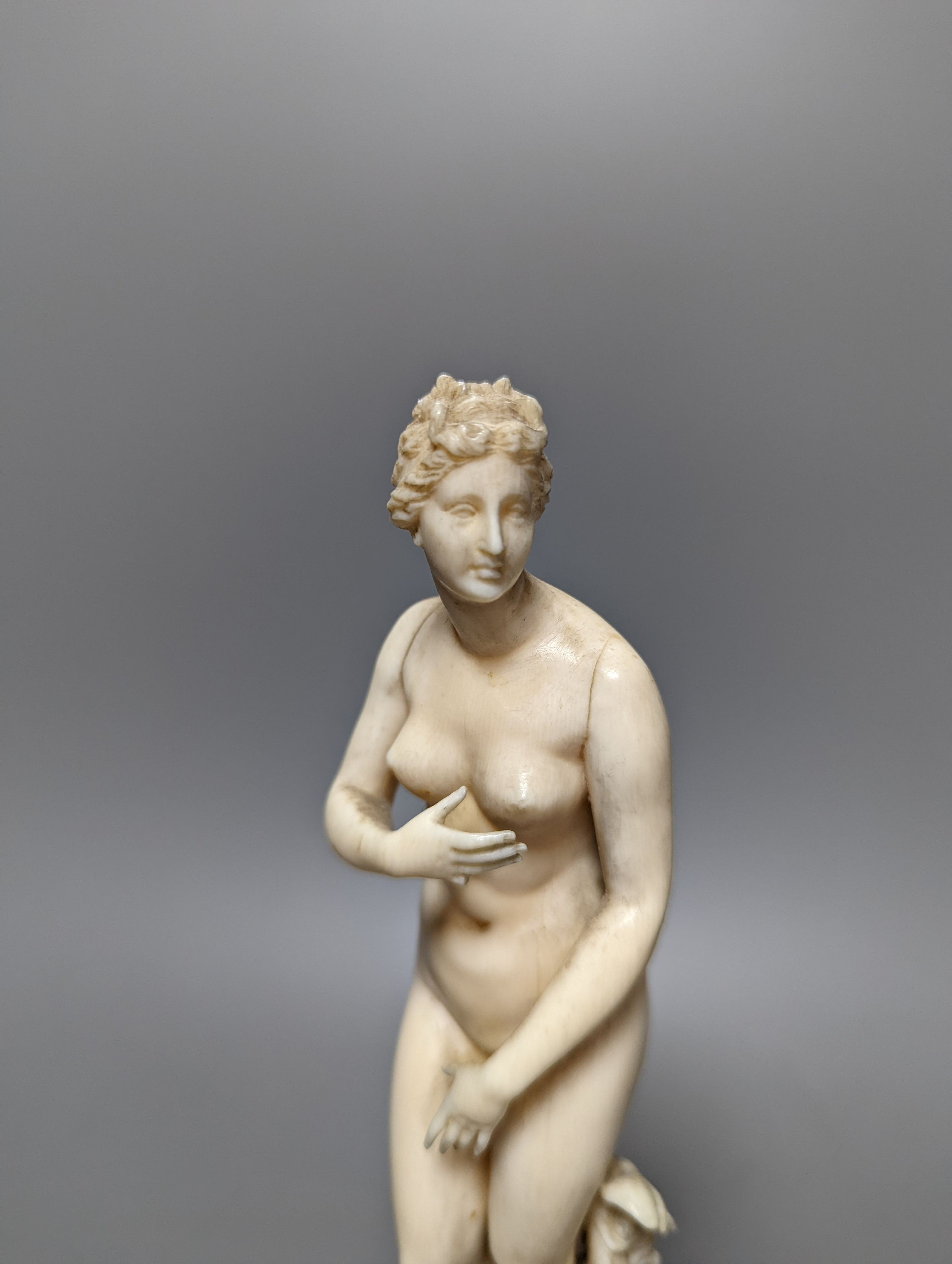 A 19th century Dieppe ivory figure after the antique ‘Venus with dolphin’ 25cm